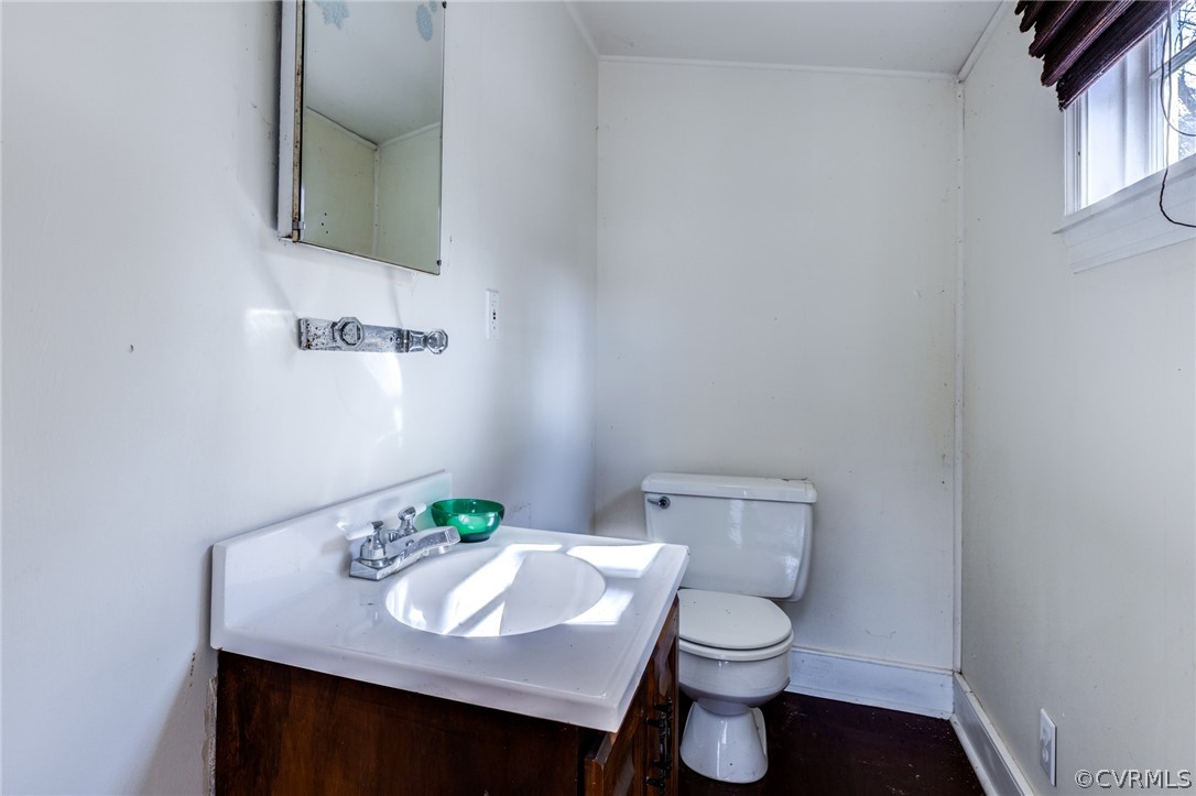 1037 Broad St Road Manakin-Sabot, VA 23103 - Photo 30 of 50 a bathroom with a sink a toilet and mirror