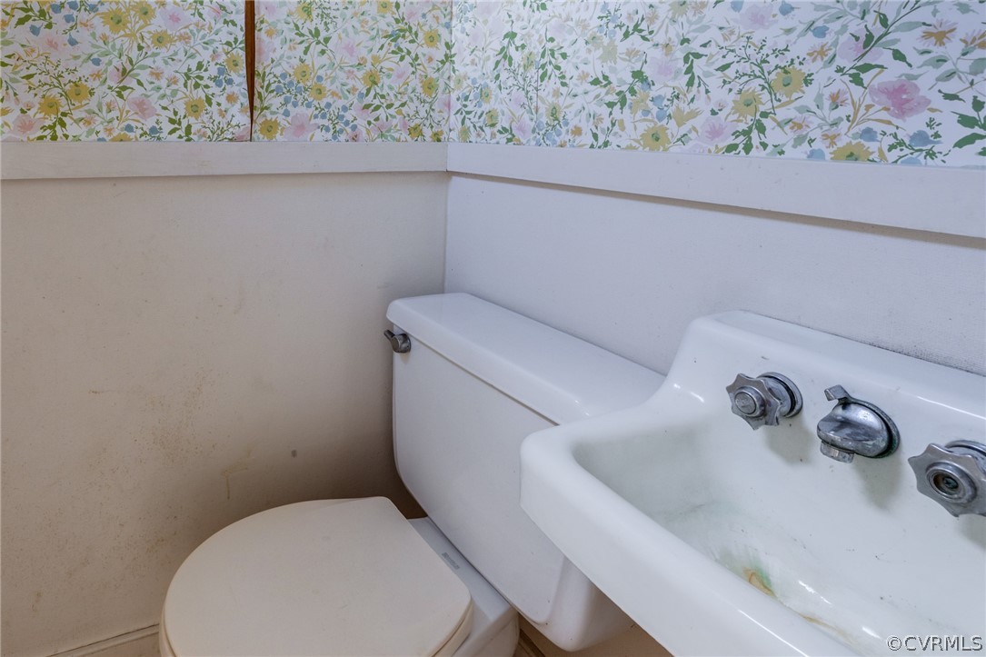 1037 Broad St Road Manakin-Sabot, VA 23103 - Photo 38 of 50 a bathroom with a toilet and sink