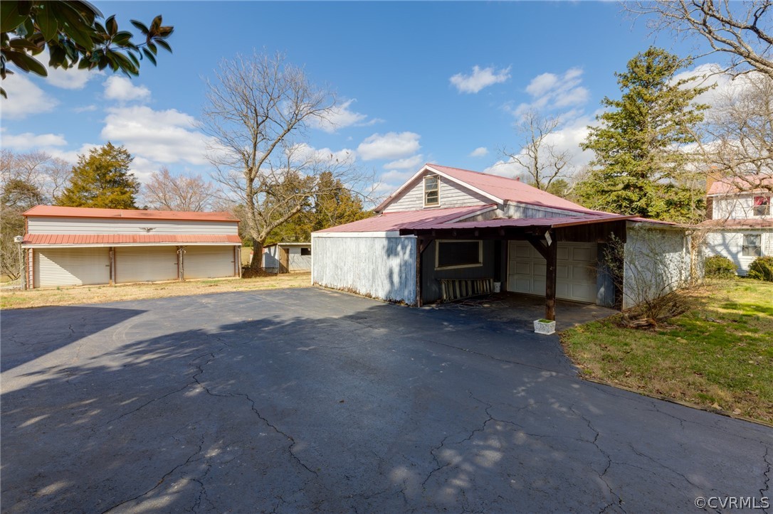1037 Broad St Road Manakin-Sabot, VA 23103 - Photo 10 of 50 a front view of a house with a yard and garage