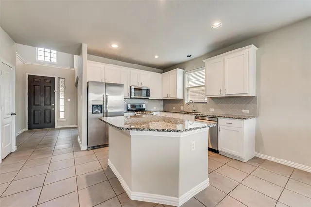 a kitchen with a stove a sink and a refrigerator
