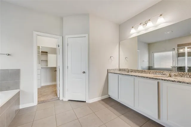 a bathroom with a double vanity sink and a mirror
