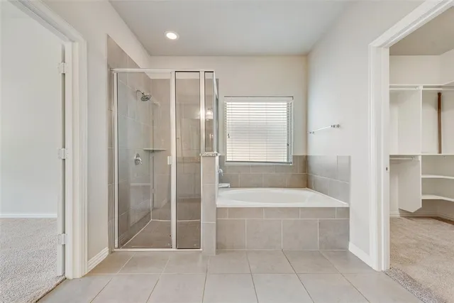 a bathroom with a shower and a tub