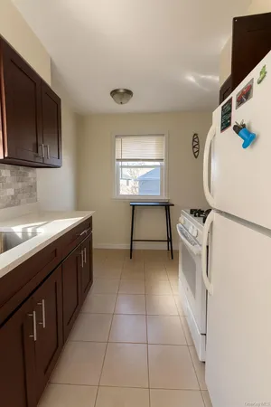 a kitchen with a sink cabinets and appliances
