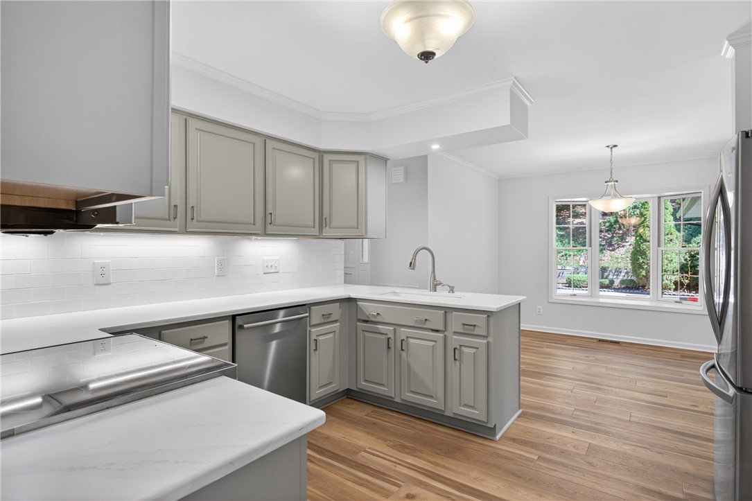 9 Lookout Lane Salem, SC 29676 - Photo 5 of 46 A well-lit kitchen with sleek gray cabinetry and durable wood flooring.