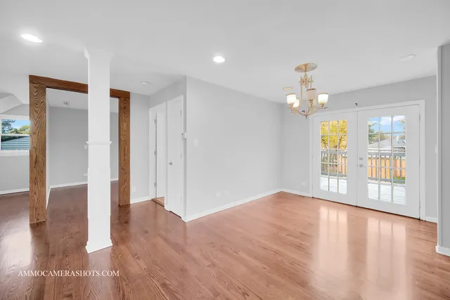 a view of a kitchen with a sink dishwasher cabinets and wooden floor