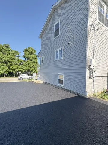 a front view of a house with a garden and yard