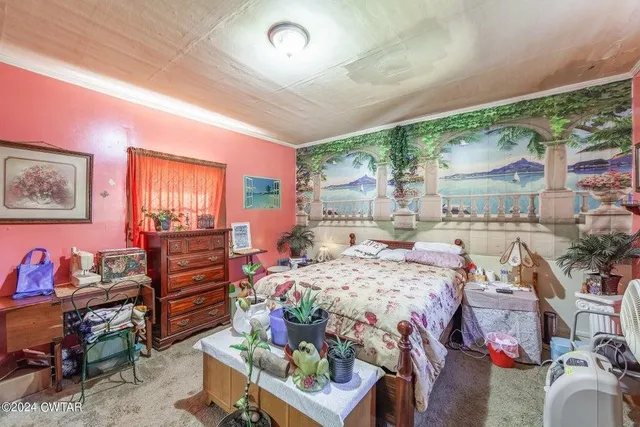 a bed room with a bed and a chair