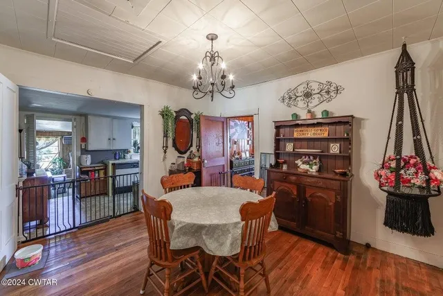 a view of a dining room with furniture wooden floor and a chandelier