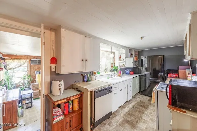 a kitchen that has a lot of cabinets in it and a window