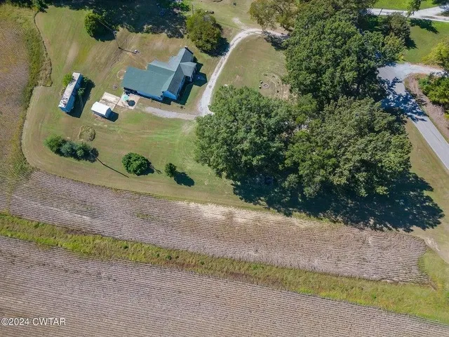 an aerial view of a house with a yard