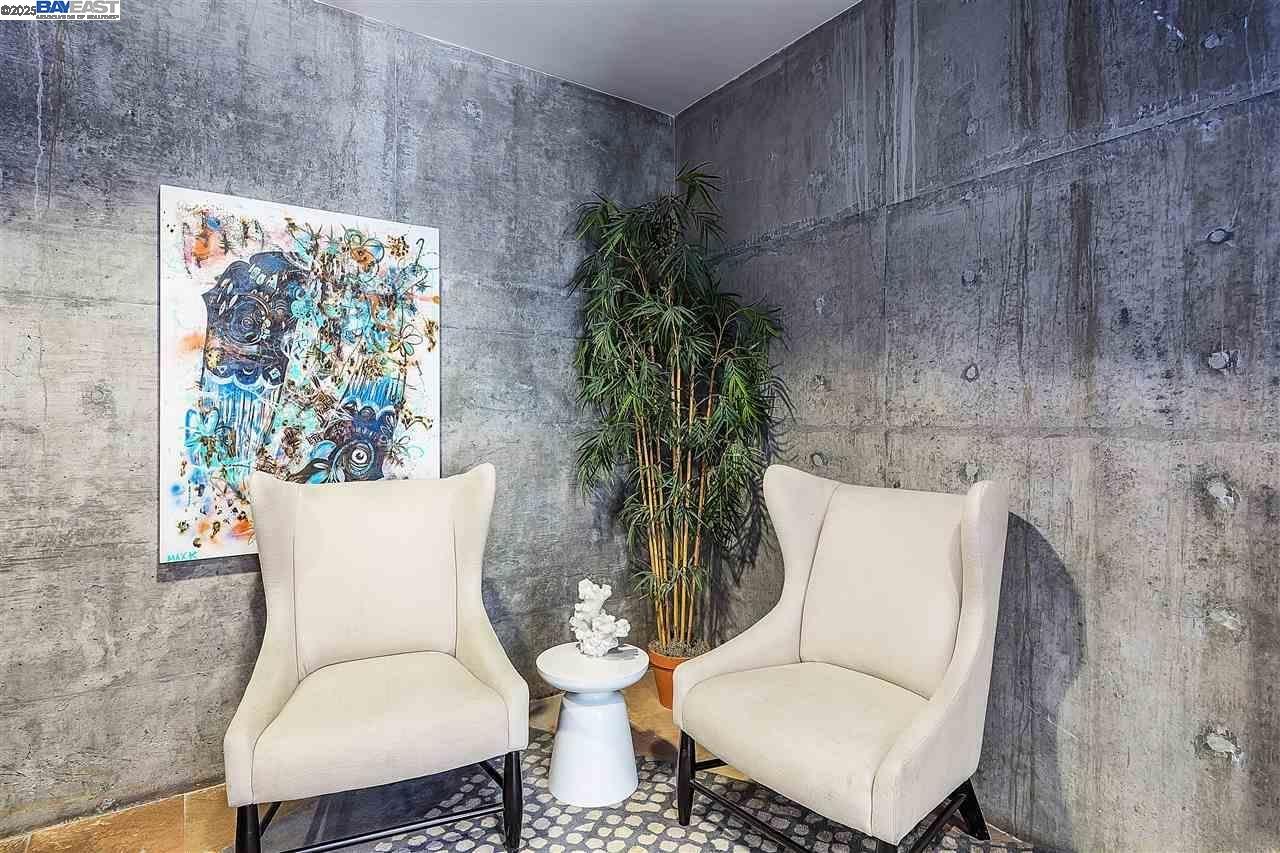 630 Thomas L Berkley Way, Unit 102 Oakland, CA 94612 - Photo 19 of 20 a white vase with flowers and a bench sitting next to a window