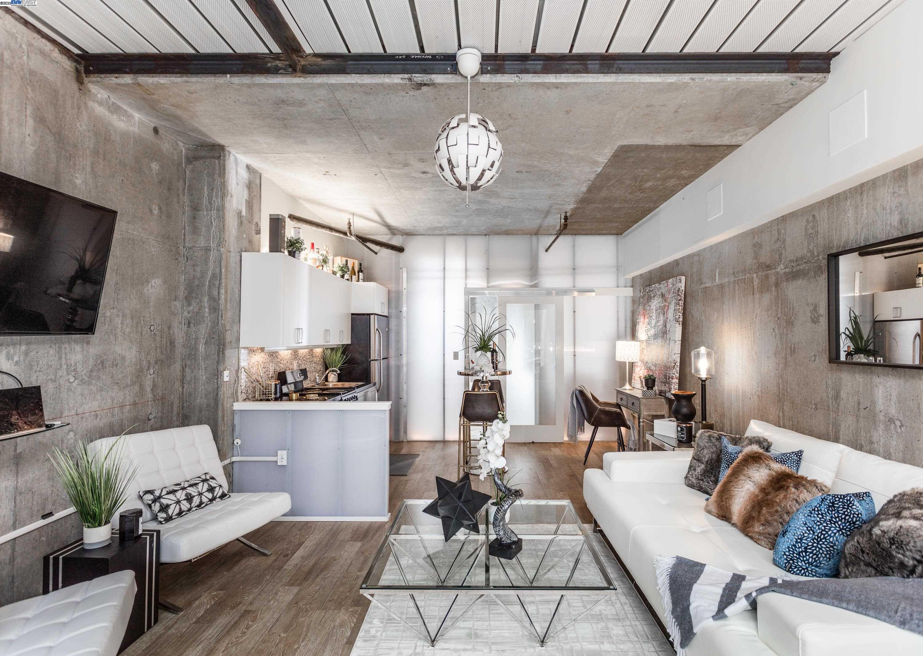 630 Thomas L Berkley Way, Unit 102 Oakland, CA 94612 - Photo 6 of 20 a living room with furniture a rug and a chandelier