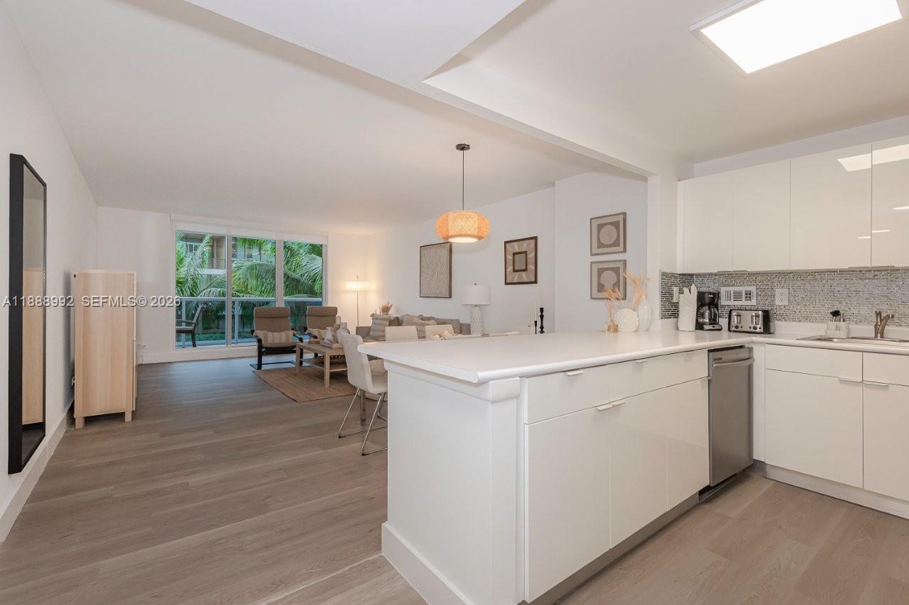 2301 Collins Avenue, Unit 333 Miami Beach, FL 33139 - Photo 18 of 37 a kitchen with a sink stove and refrigerator