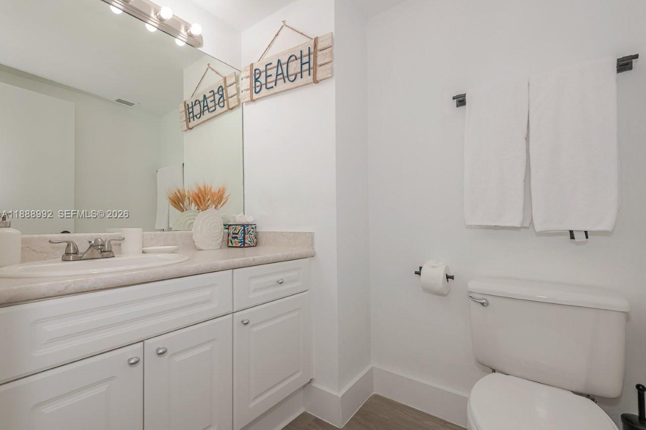 2301 Collins Avenue, Unit 333 Miami Beach, FL 33139 - Photo 19 of 37 a bathroom with a toilet sink and mirror