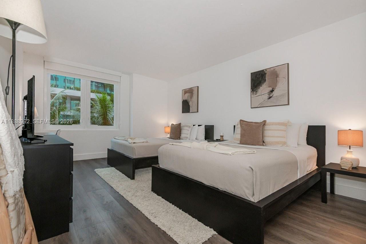 2301 Collins Avenue, Unit 333 Miami Beach, FL 33139 - Photo 20 of 37 a bedroom with a bed and a couch