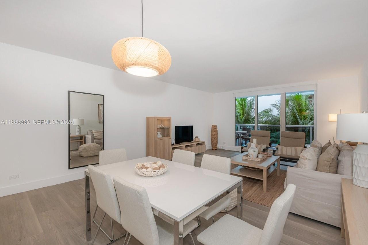2301 Collins Avenue, Unit 333 Miami Beach, FL 33139 - Photo 2 of 37 a view of a dining room with furniture wooden floor and chandelier