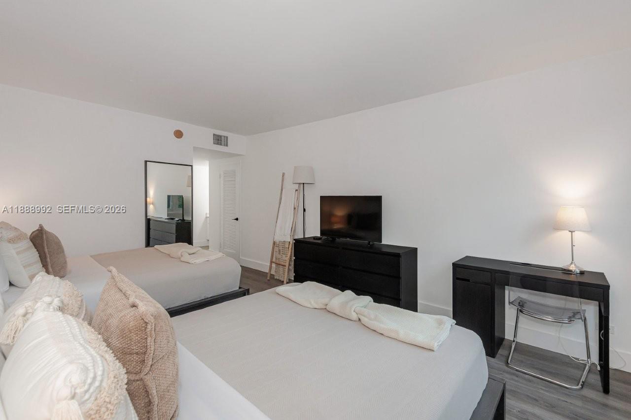 2301 Collins Avenue, Unit 333 Miami Beach, FL 33139 - Photo 22 of 37 a bedroom with a bed and a television