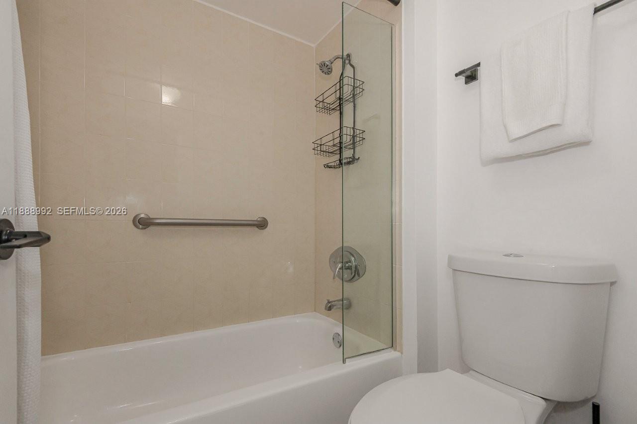 2301 Collins Avenue, Unit 333 Miami Beach, FL 33139 - Photo 25 of 37 a bathroom with a toilet and a bathtub