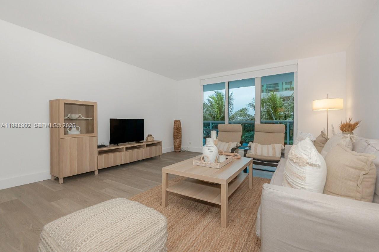 2301 Collins Avenue, Unit 333 Miami Beach, FL 33139 - Photo 3 of 37 a living room with furniture and a flat screen tv