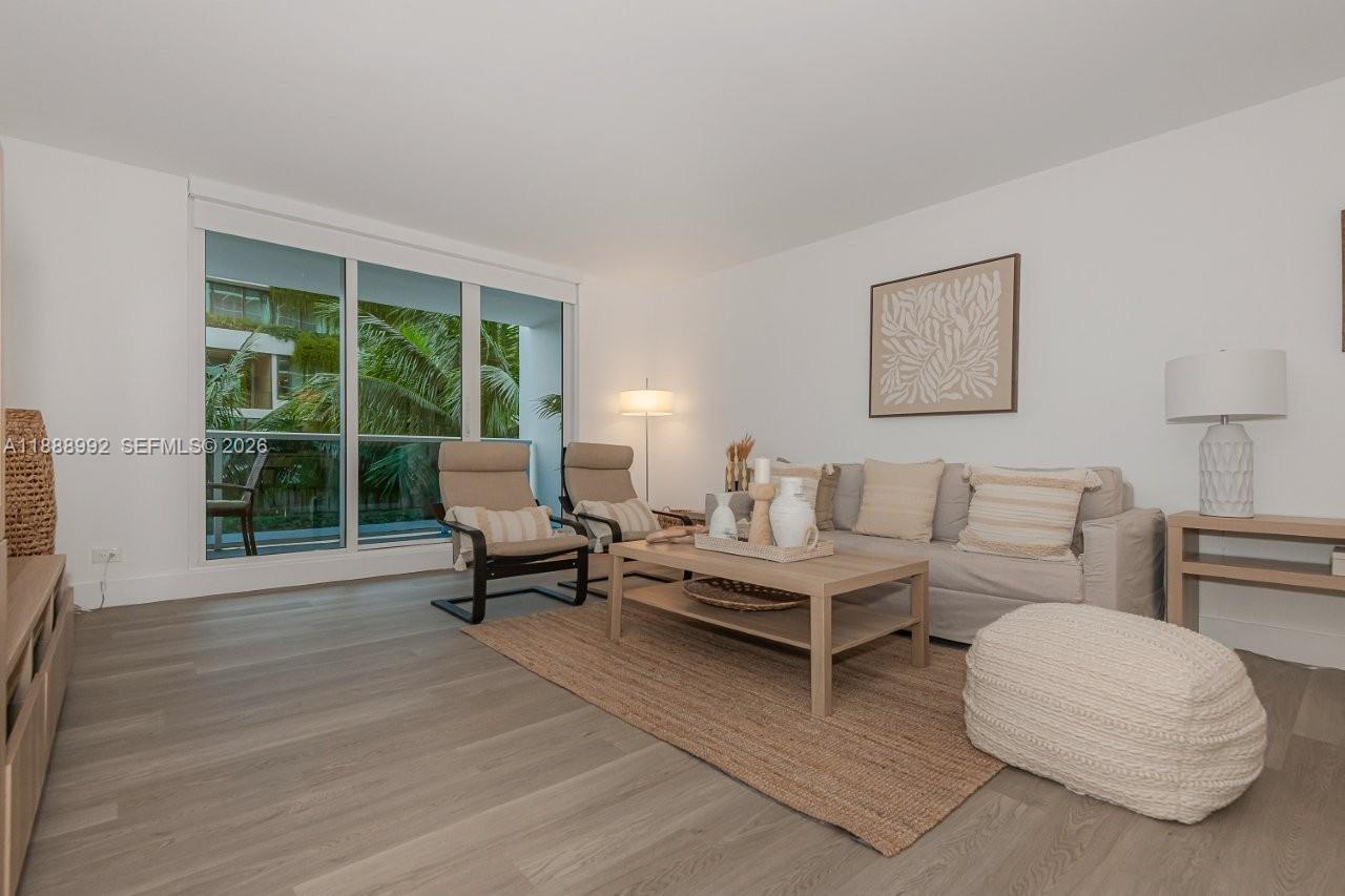 2301 Collins Avenue, Unit 333 Miami Beach, FL 33139 - Photo 4 of 37 a living room with furniture and a large window