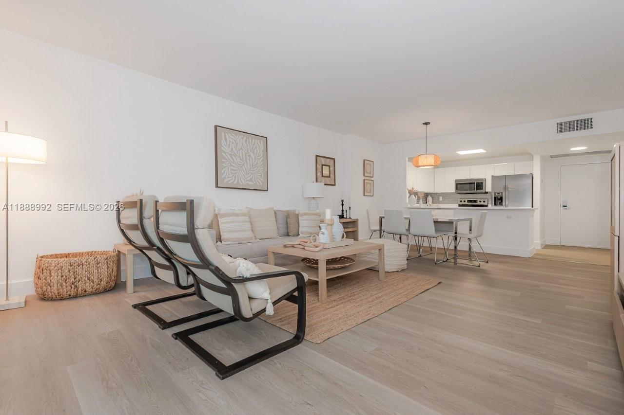 2301 Collins Avenue, Unit 333 Miami Beach, FL 33139 - Photo 6 of 37 a living room with furniture and kitchen view