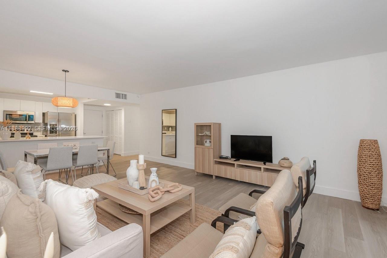 2301 Collins Avenue, Unit 333 Miami Beach, FL 33139 - Photo 7 of 37 a living room with furniture a rug and a flat screen tv