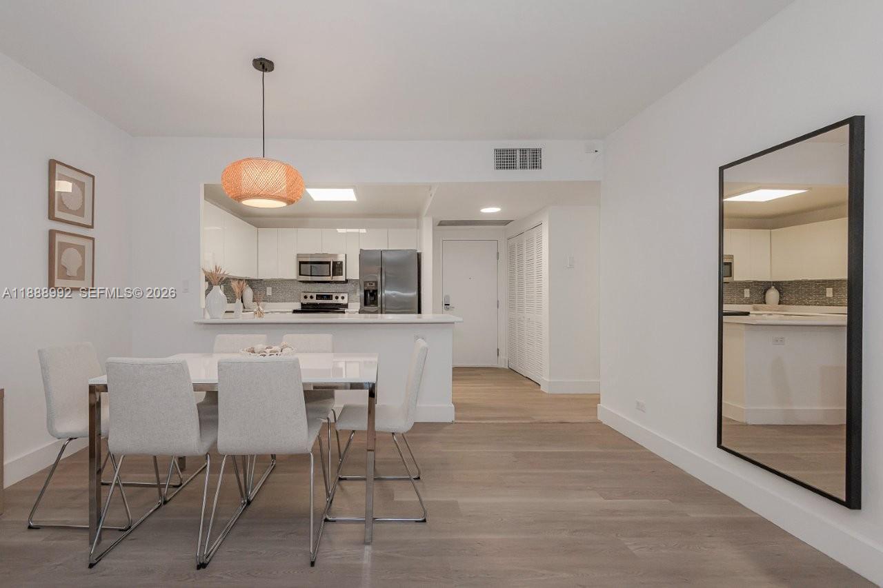 2301 Collins Avenue, Unit 333 Miami Beach, FL 33139 - Photo 9 of 37 a kitchen with kitchen island white cabinets and refrigerator