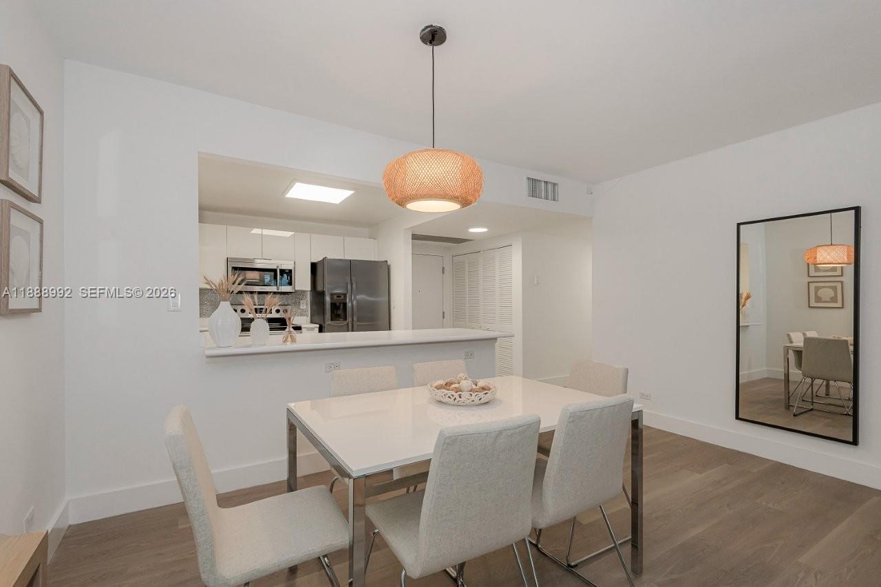 2301 Collins Avenue, Unit 333 Miami Beach, FL 33139 - Photo 10 of 37 a dining room with a table and chairs
