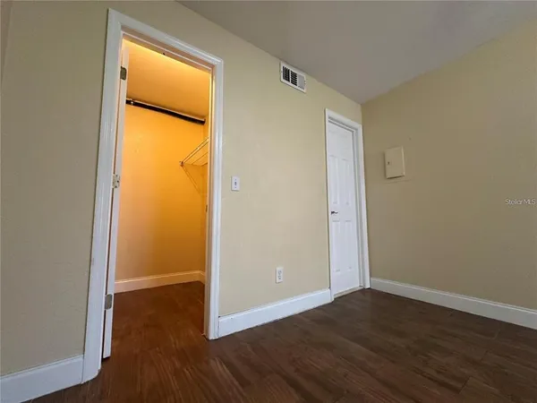 an empty room with wooden floor and a window