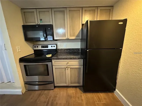 a kitchen with a refrigerator and stove