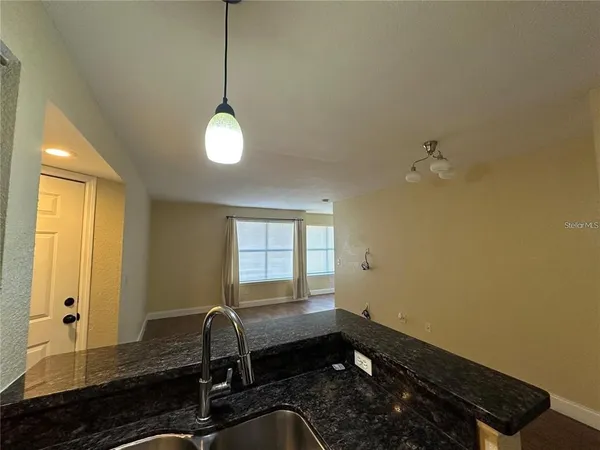 a room with exposed radiator and windows