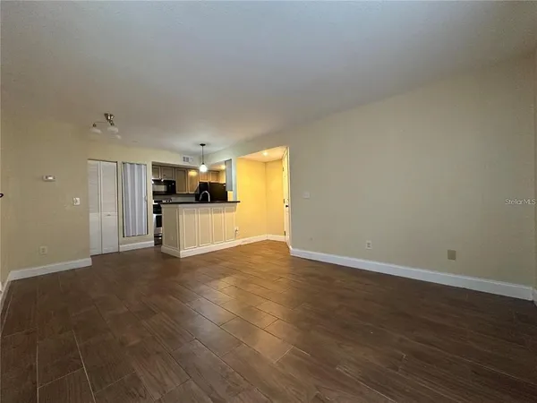 a view of a kitchen with a sink and a refrigerator