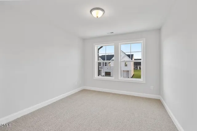 an empty room with windows and entrance