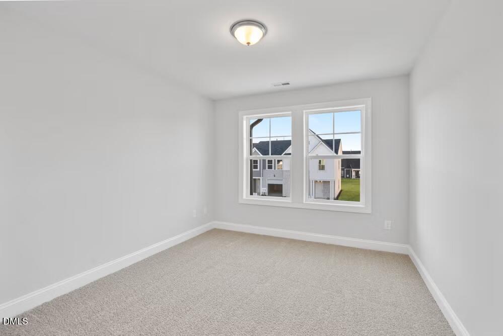 520 Eversden Drive Zebulon, NC 27597 - Photo 14 of 24 an empty room with windows and entrance