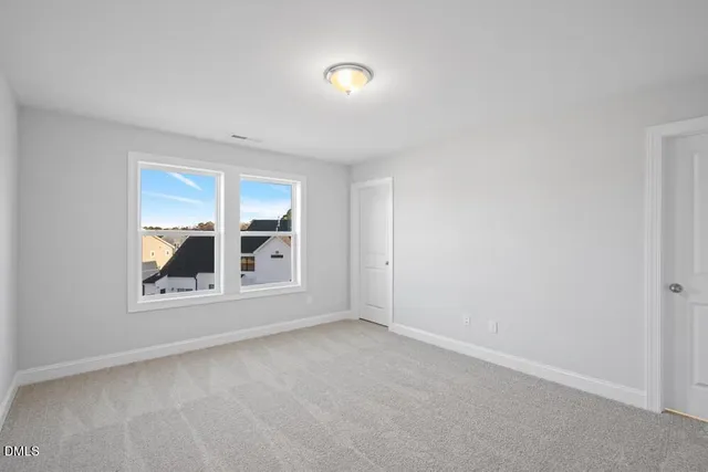 a view of wooden floor chandelier and windows in a room