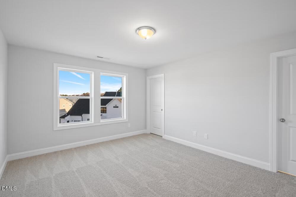 520 Eversden Drive Zebulon, NC 27597 - Photo 15 of 24 a view of wooden floor chandelier and windows in a room