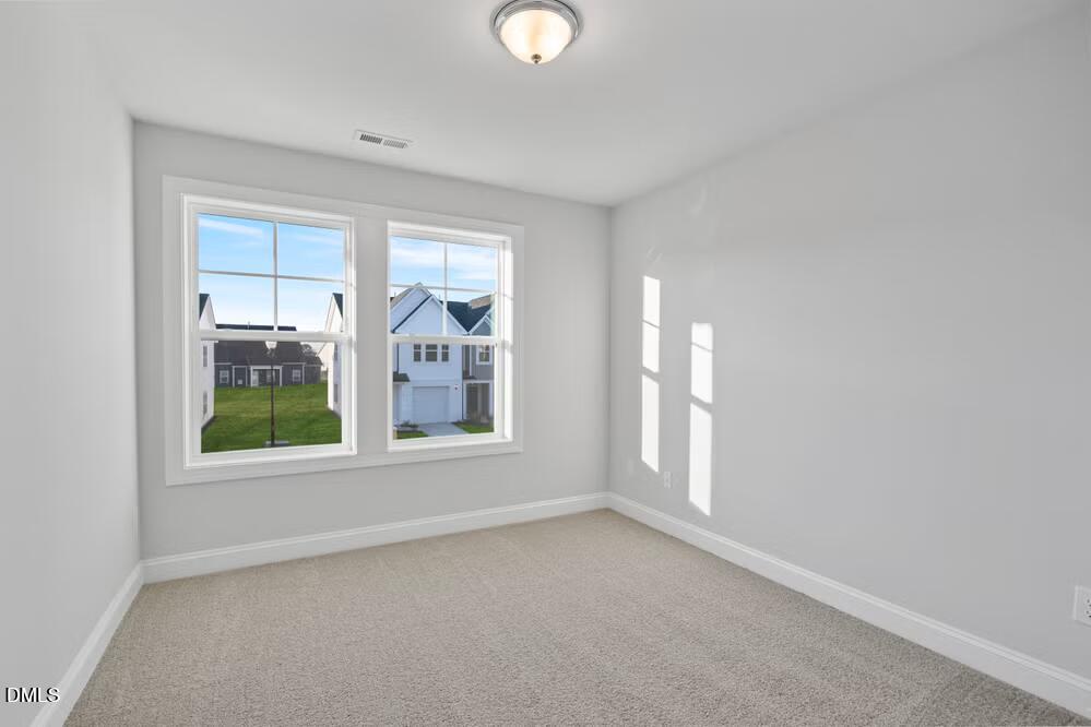 520 Eversden Drive Zebulon, NC 27597 - Photo 16 of 24 an empty room with windows and entrance