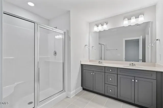 a spacious bathroom with a double vanity sink mirror and double