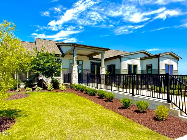 a view of a house with a yard porch and sitting area