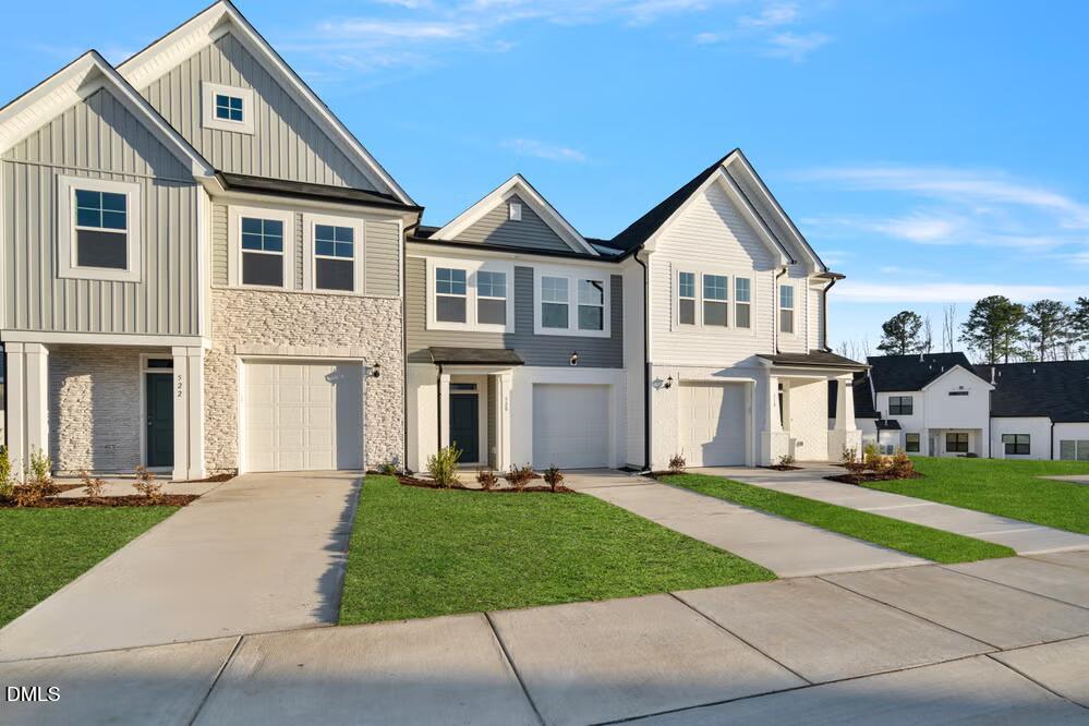 520 Eversden Drive Zebulon, NC 27597 - Photo 3 of 24 a front view of a house with a yard and trees