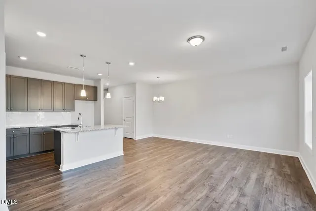 a large kitchen with stainless steel appliances granite countertop a sink and cabinets