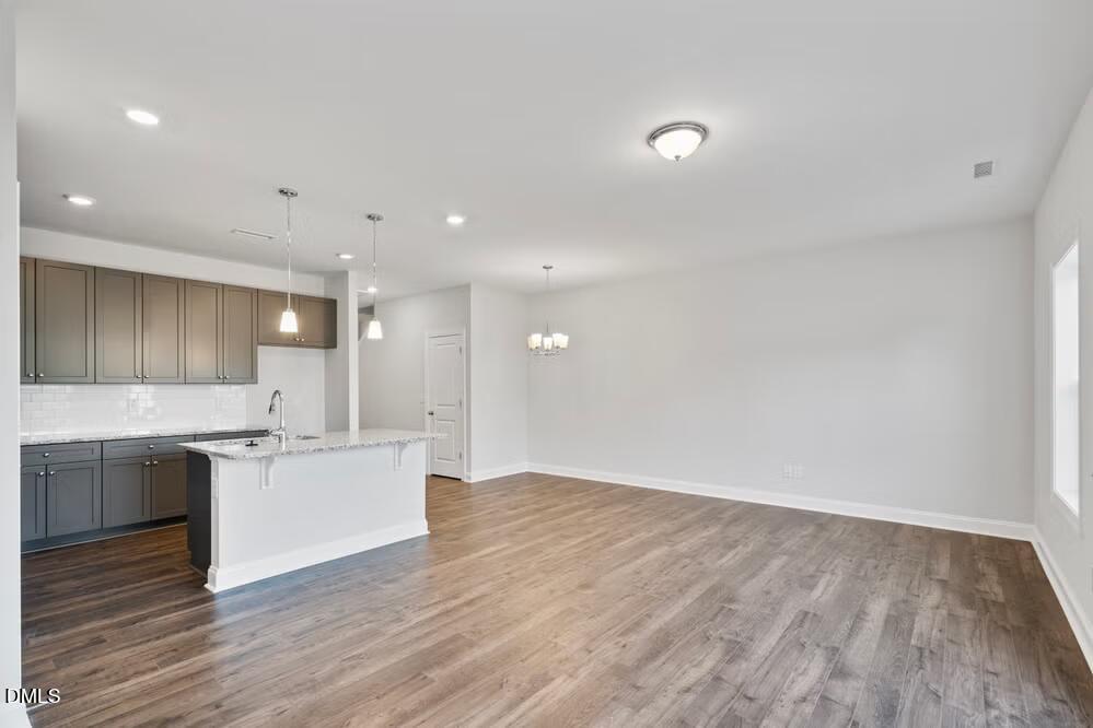 520 Eversden Drive Zebulon, NC 27597 - Photo 10 of 24 a large kitchen with stainless steel appliances granite countertop a sink and cabinets
