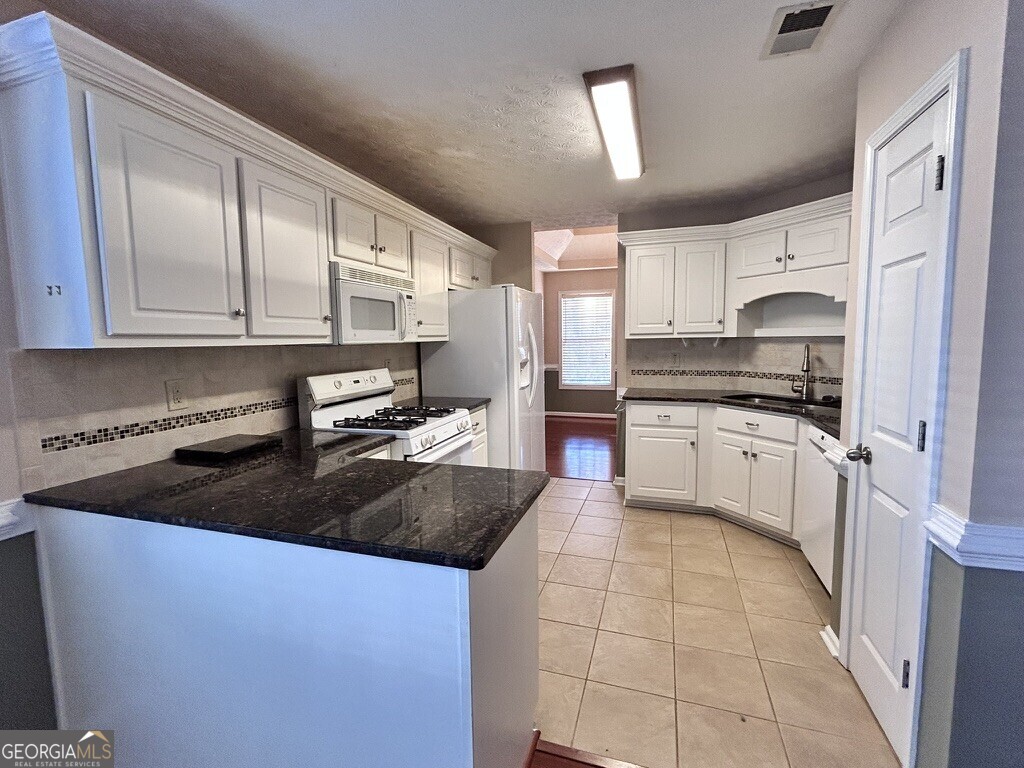 70 Camerons Way Covington, GA 30016 - Photo 6 of 23 Granite countertops, pantry and all appliances in kitchen