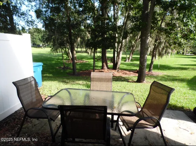 a view of an outdoor sitting area with furniture and garden