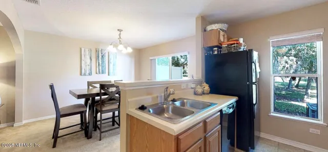 a kitchen that has a table and chairs in it