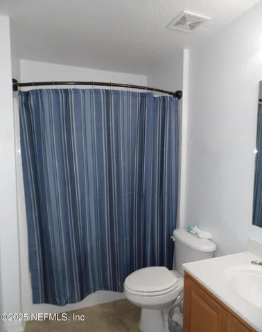a bathroom with a toilet a sink and a shower