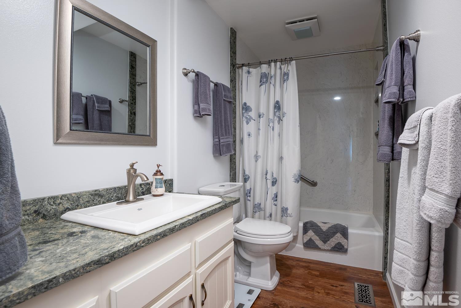 270 Kitts Way Reno, NV 89521 - Photo 13 of 16 a bathroom with a granite countertop sink toilet and shower