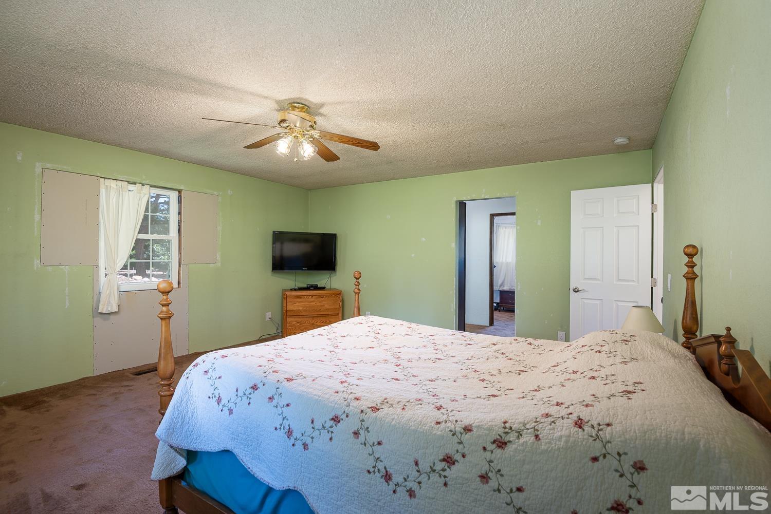 270 Kitts Way Reno, NV 89521 - Photo 14 of 16 a bedroom with a bed and a flat screen tv