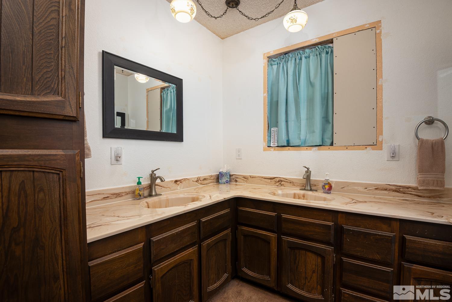 270 Kitts Way Reno, NV 89521 - Photo 15 of 16 a bathroom with a double vanity sink and a mirror