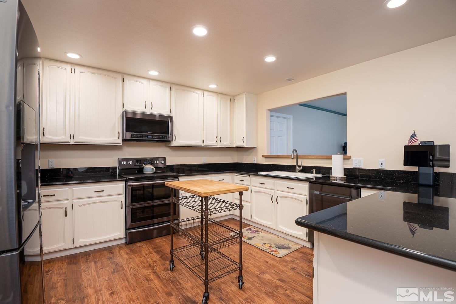 270 Kitts Way Reno, NV 89521 - Photo 16 of 16 a kitchen with stainless steel appliances a stove a sink a stove a microwave a refrigerator and cabinets